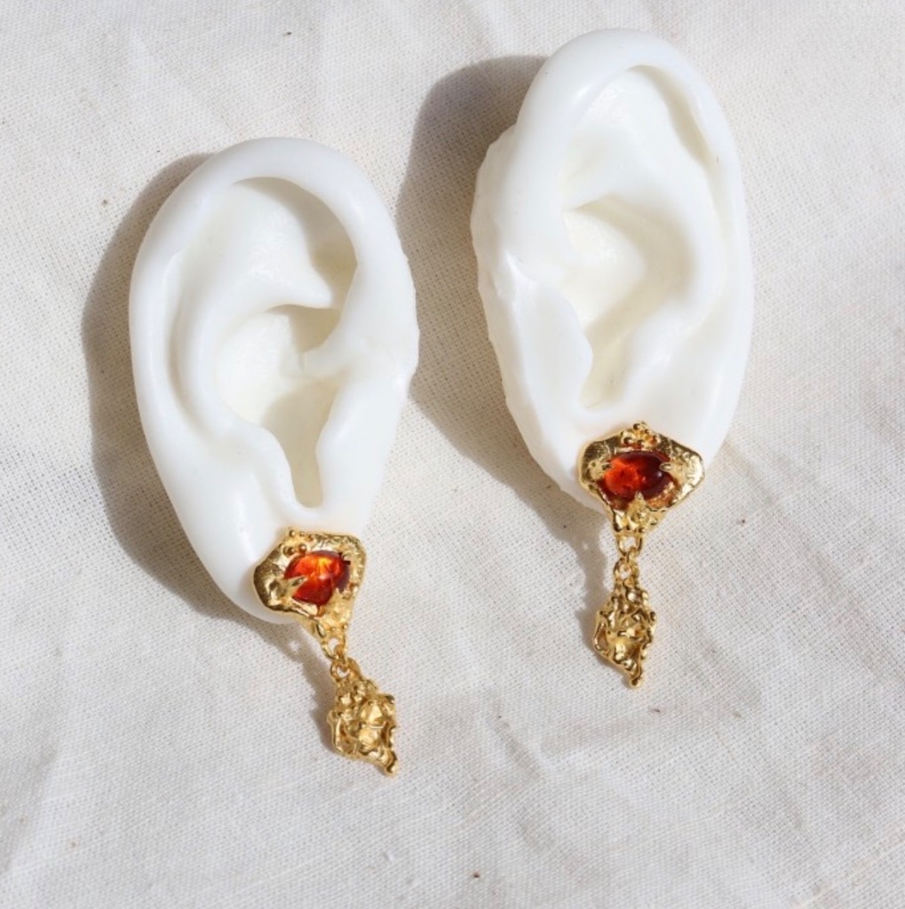 Ember Garnet Drop Earrings on ear mold